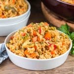 An angled view of a bowl filled with fried rice loaded with bright colored sauteed vegetables - Hostess at Heart