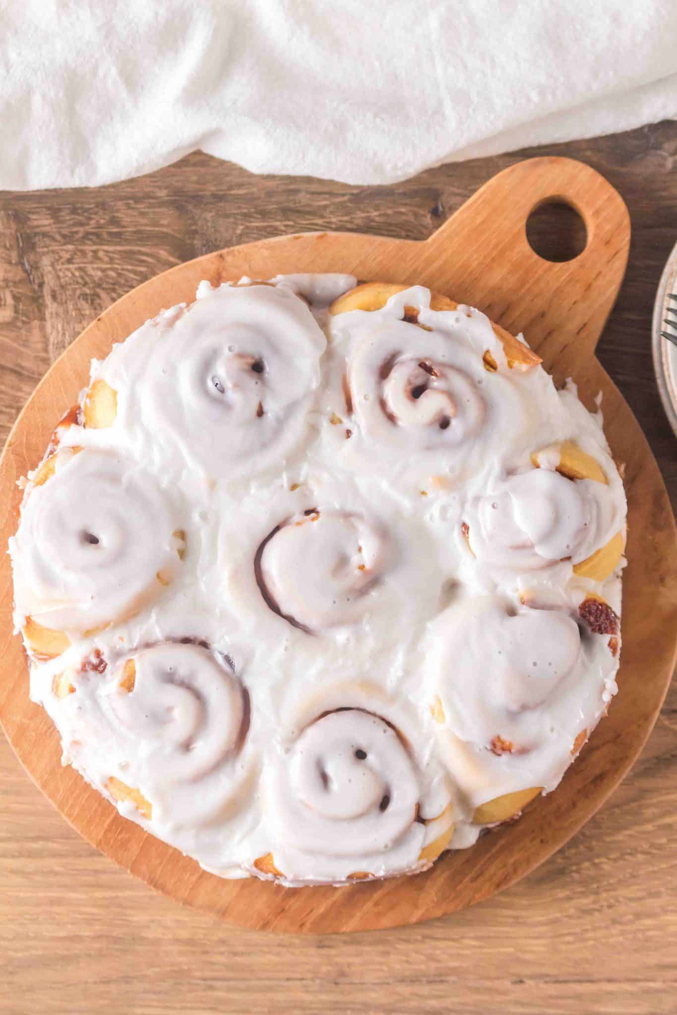 Top down view image of a circle of 8 baked and frosted cinnamon rolls sourdough - Hostess At Heart