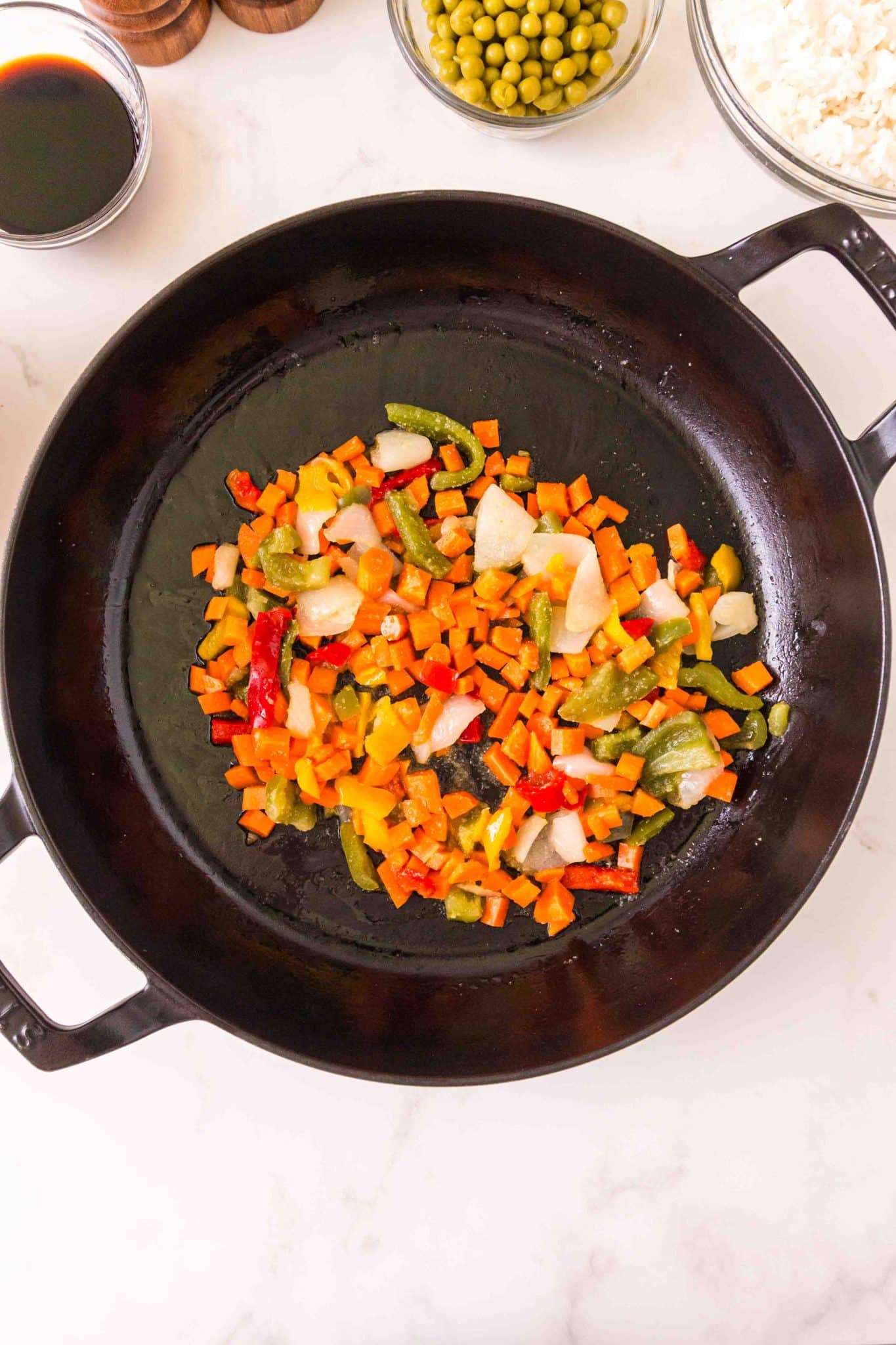 Top down view of a skillet filled with brightly colored sauteed vegetables - Hostess At Heart