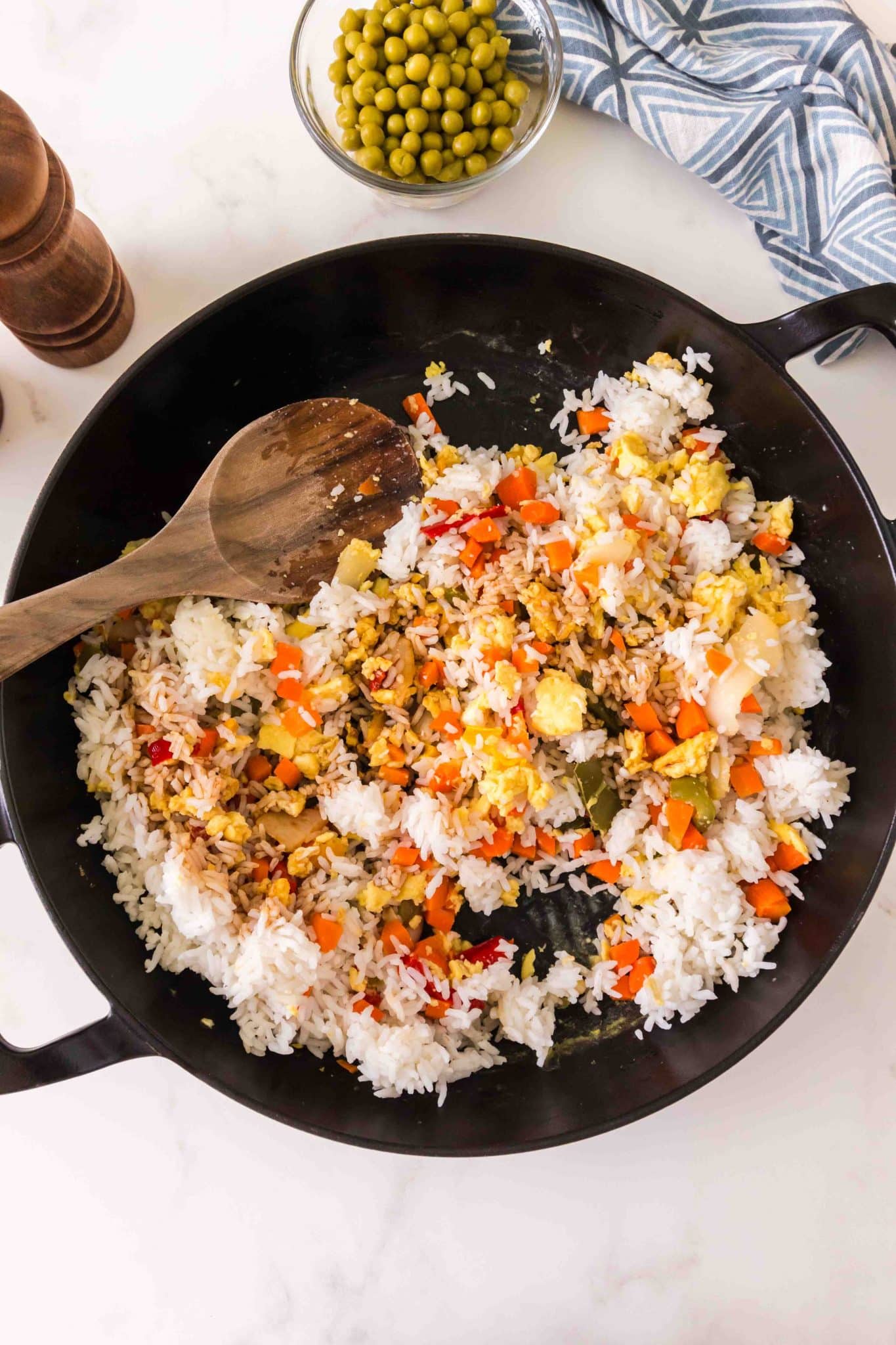 A top down image showing how to combine rice with sauteed vegetables - Hostess At Heart