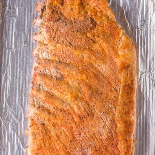 Baked pork ribs taken out of the oven before applying barbecue sauce.