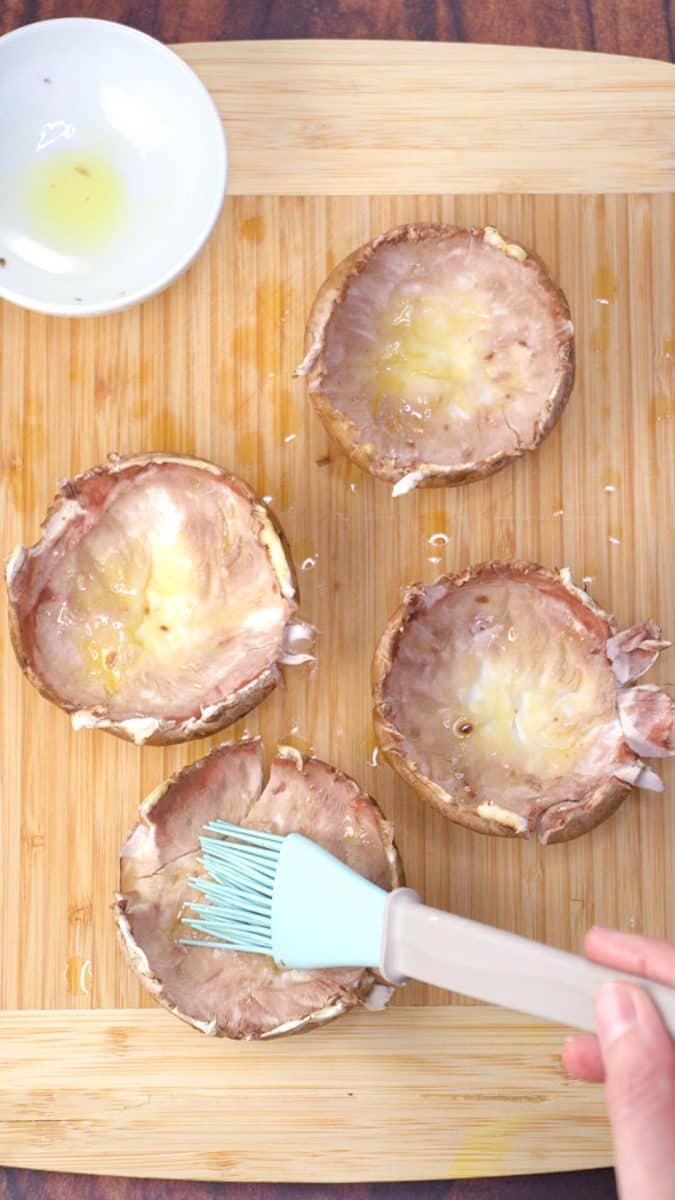 A basting brush applying oil to mushroom caps. Hostess At Heart