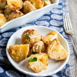 Closeup view of a plate topped with chunks of roasted potatoes with parmesan - Hostess At Heart
