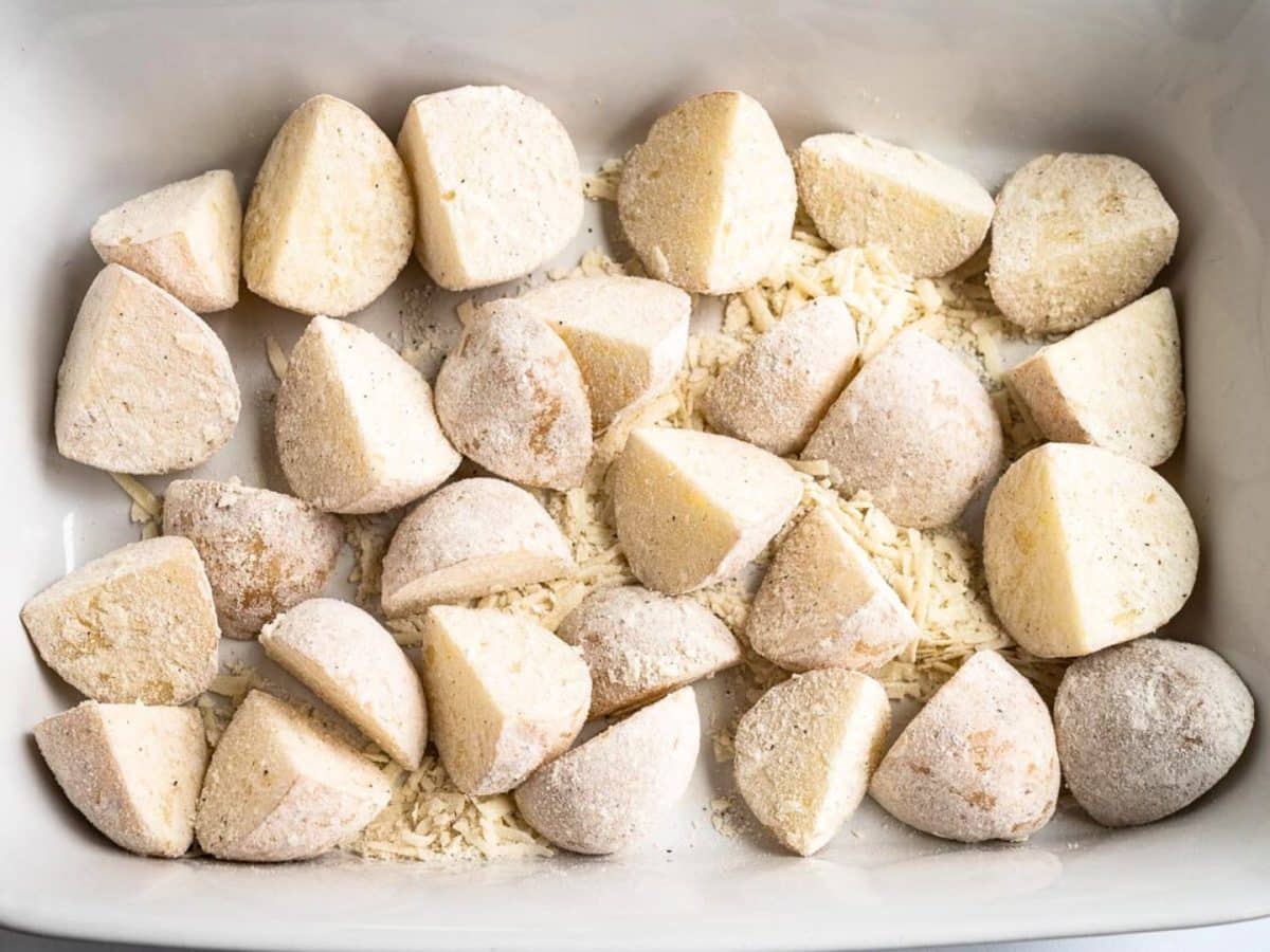 Chunks of potatoes that were shaken with flour, parmesan cheese, salt and pepper to coat prior to baking - Hostess At Heart