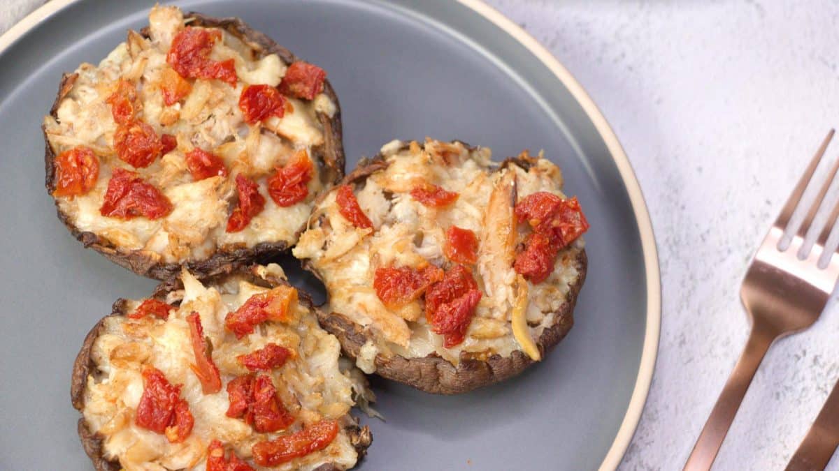Top down view of baked mushrooms stuffed with crab, cheese, and sundried tomatoes - Hostess At Heart