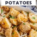 An image for Pinterest of Golden Brown Crispy Parmesan cheese roasted potatoes in a baking dish - Hostess At Heart