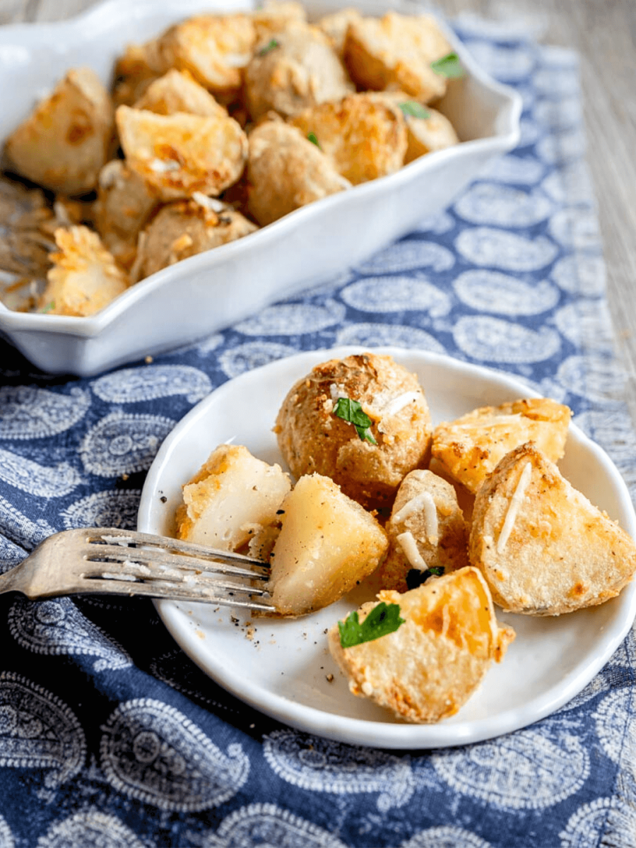 Angled view of crispy roasted potatoes with parmesan cheese - Hostess At Heart