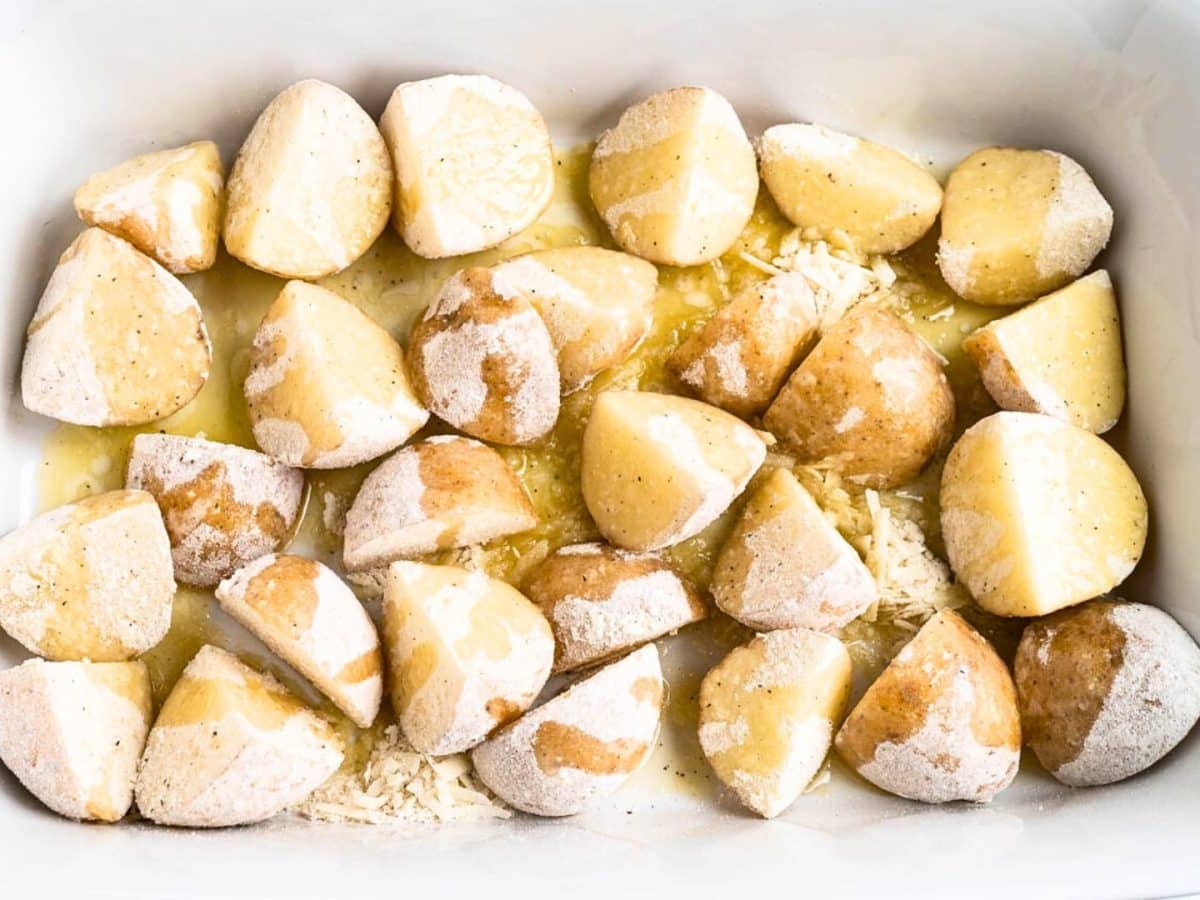 Chunks of potatoes that were shaken with flour, parmesan cheese, salt and butter then drizzled with butter - Hostess At Heart