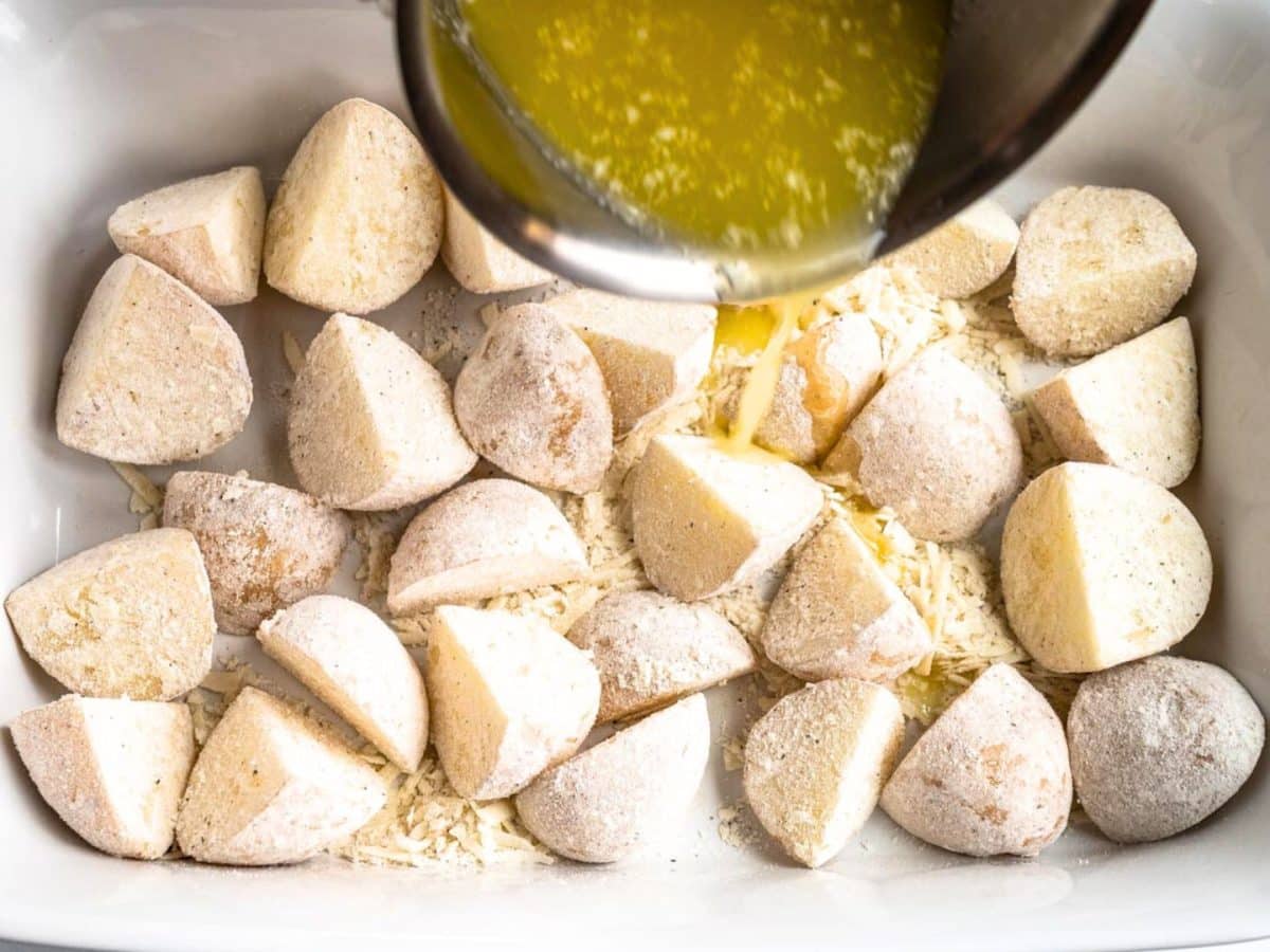 Melted butter poured over chunks of potatoes that were shaken with flour, parmesan cheese, salt and butter - Hostess At Heart
