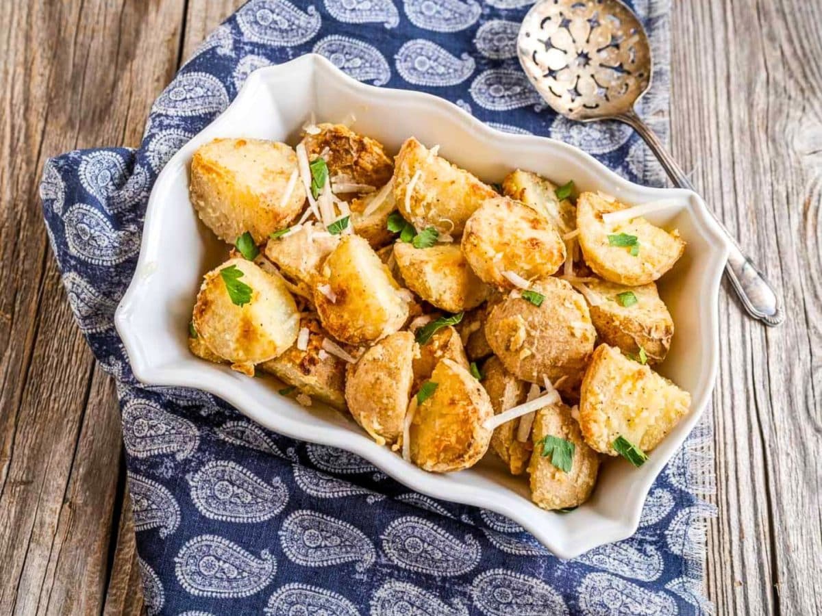 Angled top view of a baking dish filled with Parmesan Roasted Potatoes - Hostess At Heart