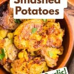 An image for Pinterest of Garlic Smashed Potatoes garnished with chopped parsley - Hostess At Heart