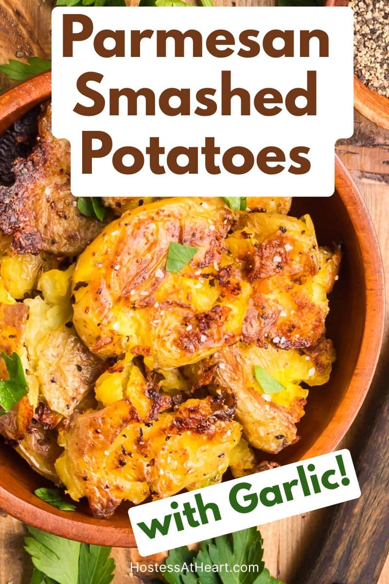 An image for Pinterest of Garlic Smashed Potatoes garnished with chopped parsley - Hostess At Heart