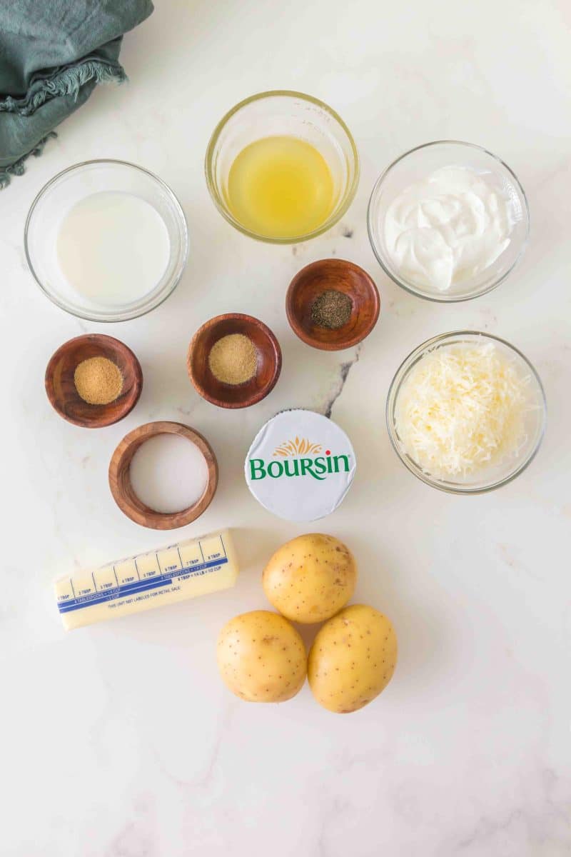 Boursin Cheese Potato casserole recipe ingredients: Yukon potatoes, butter, milk, Boursin cheese, parmesan cheese, garlic powder, onion powder, salt, pepper, and sour cream in individual dishes - Hostess At Heart