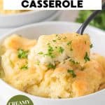 A titled image for Pinterest of a bowl of creamy Boursin Mashed Potatoes with a spoon hovering over the bowl showing how creamy it is- Hostess At Heart