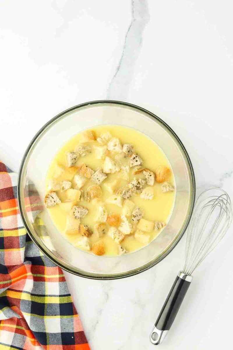 Bread cubes immersed in a bowl filled with broth mixed with eggs - Hostess At Heart