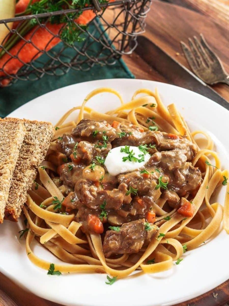 Top down view of a bowl of the best beef stroganoff recipe served over whole wheat pasta - Hostess At Heart