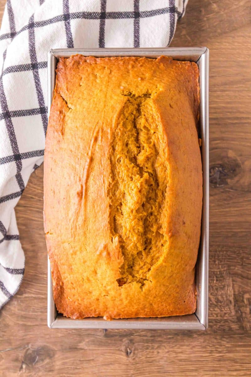 Top down view of a loaf pan filled with baked pumpkin bread - Hostess At Heart