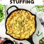 An image for Pinterest of a cast iron skillet filled with a baked fresh herb dressing for Thanksgiving - Hostess At Heart