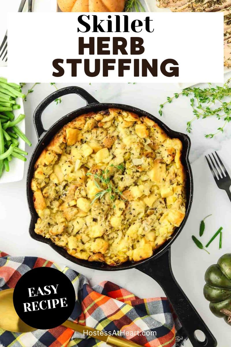 An image for Pinterest of a cast iron skillet filled with a baked fresh herb dressing for Thanksgiving - Hostess At Heart