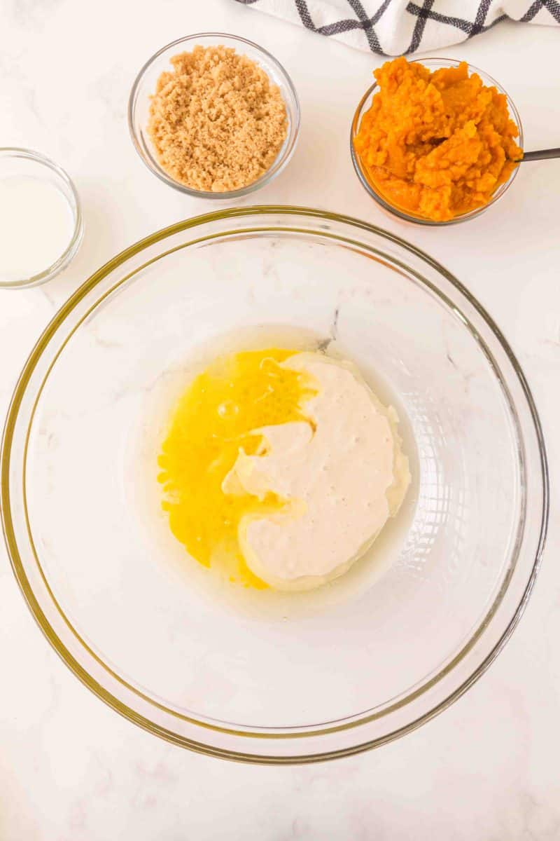 A large mixing bowl containing oil and egg whisked together - Hostess At Heart