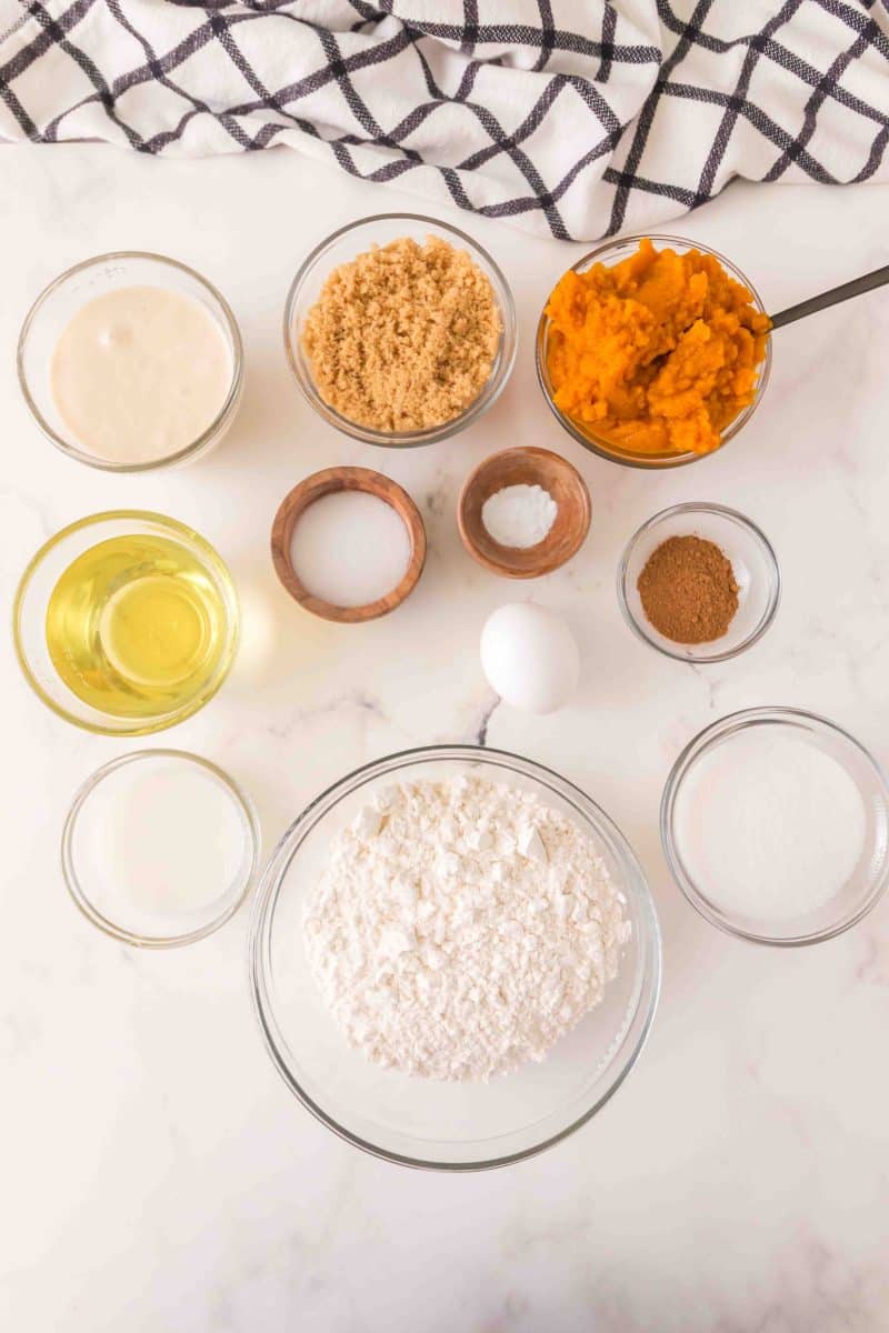 Sourdough pumpkin bread recipe ingredients: all-purpose flour, baking powder, salt, baking soda, pumpkin pie spice, oil, egg, sourdough starter discard, white sugar, brown sugar, pumpkin puree, and milk. - Hostess At Heart