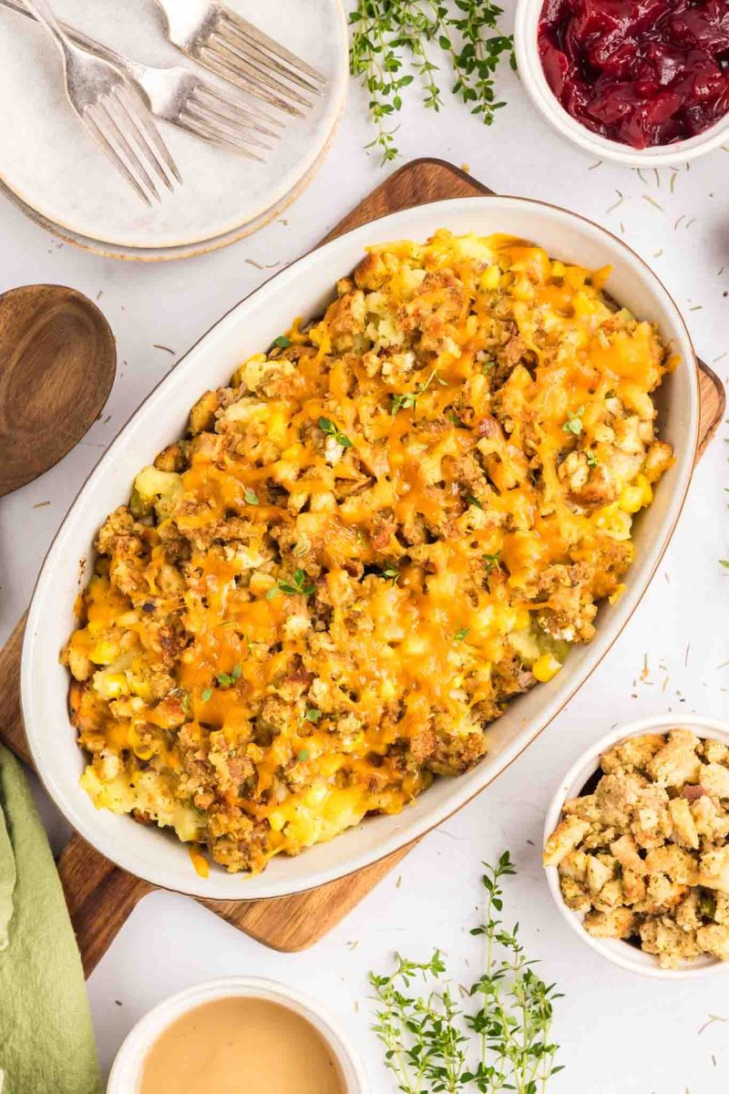 Top down view of a Thanksgiving Leftover Casserole in a baking dish with melted cheese and golden stuffing on top - Hostess At Heart