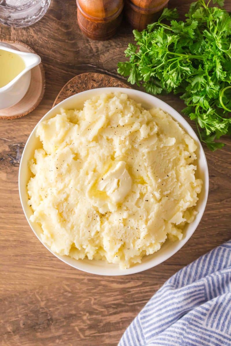 Fluffy homemade mashed potatoes with butter in a serving dish - Hostess At Heart
