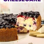 Creamy slice of blueberry cheesecake on spatula showing graham cracker crust and blueberry-studded filling - Hostess At Heart