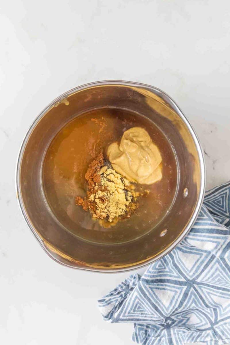 Brown sugar glaze in saucepan with honey and spices for glazed ham recipe - Hostess At Heart