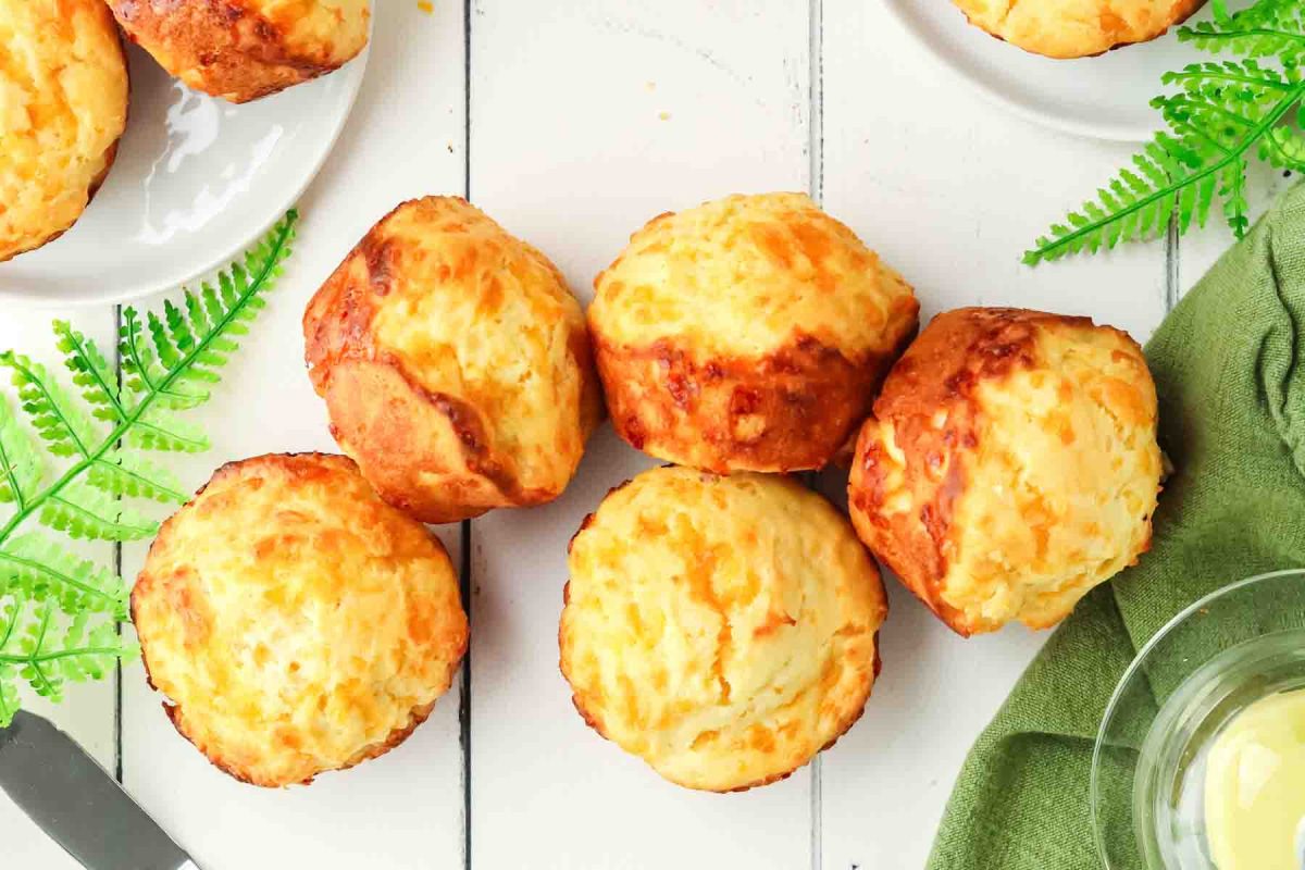 Top down view of freshly baked golden brown savory cheese muffins - Hostess At Heart