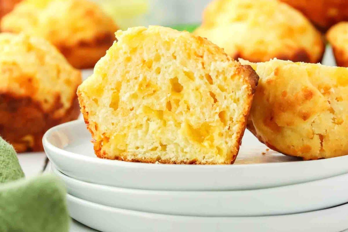 Tableview of a muffin split in half showing a fluffy cheesy interior - Hostess At Heart
