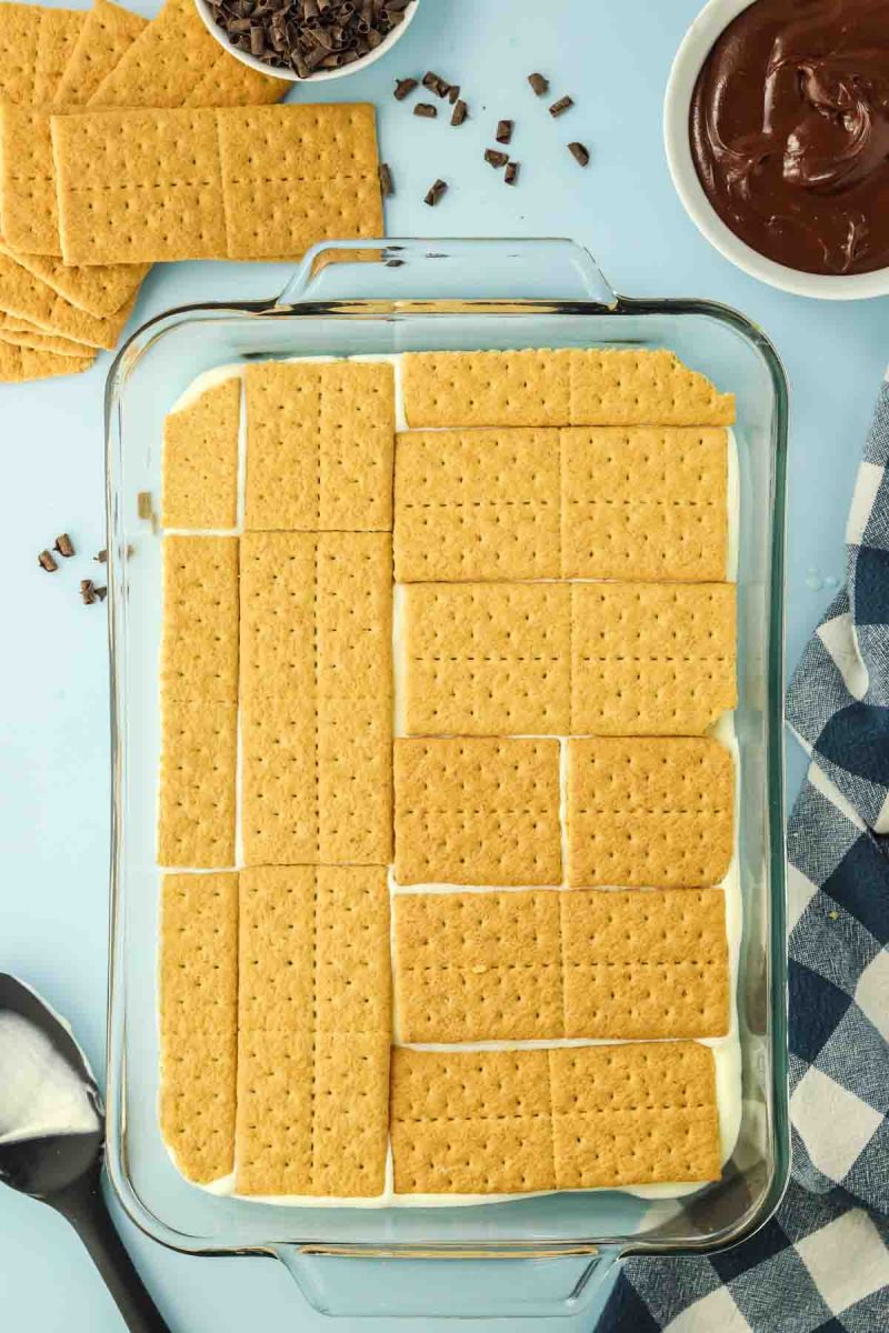 Layer of graham crackers arranged in 9x13 inch baking pan - Hostess At Heart