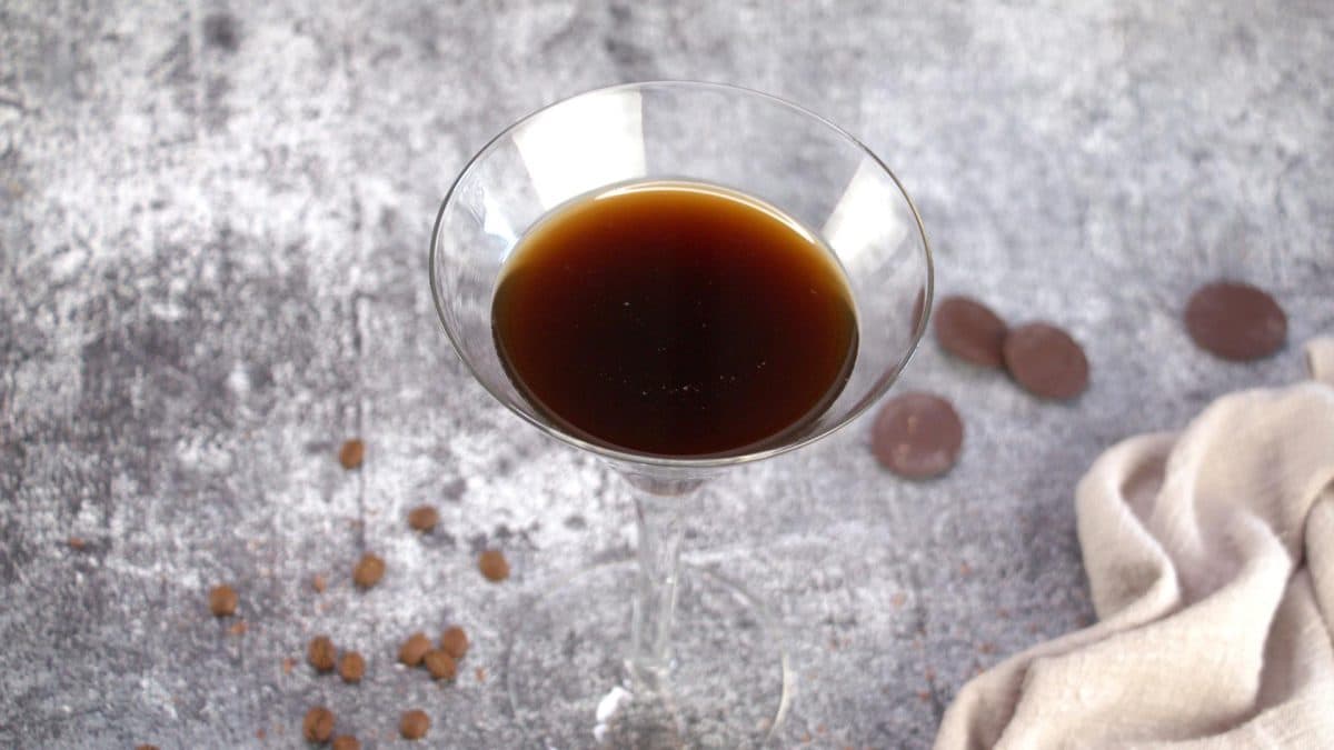 Top down view of a Chocolate coffee martini in a chilled martini glass with coffee beans - Hostess At Heart