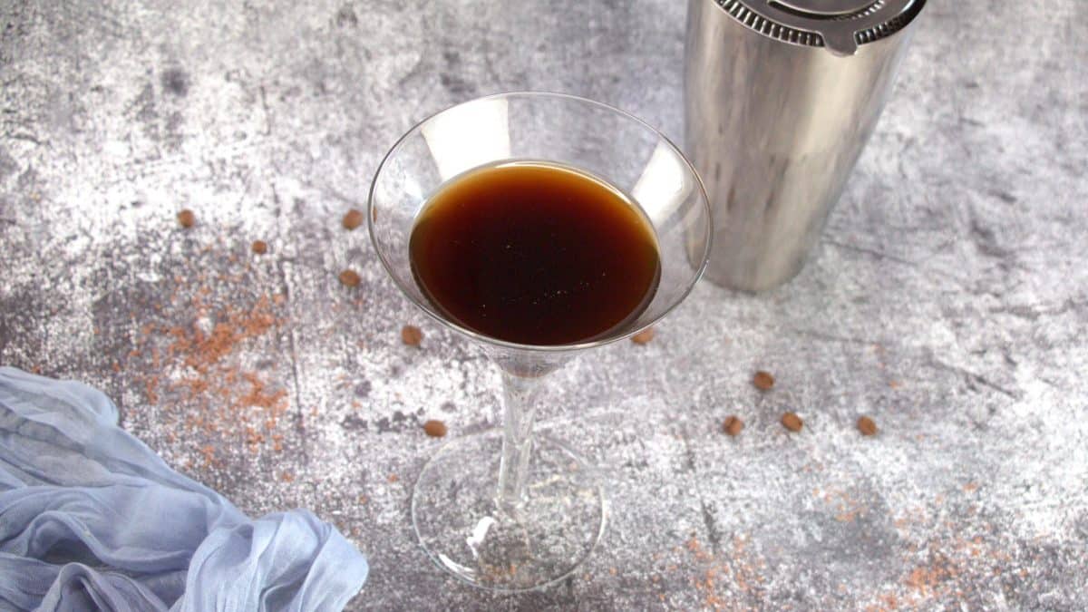 Chocolate espresso martini in a chilled martini glass with coffee beans - Hostess At Heart