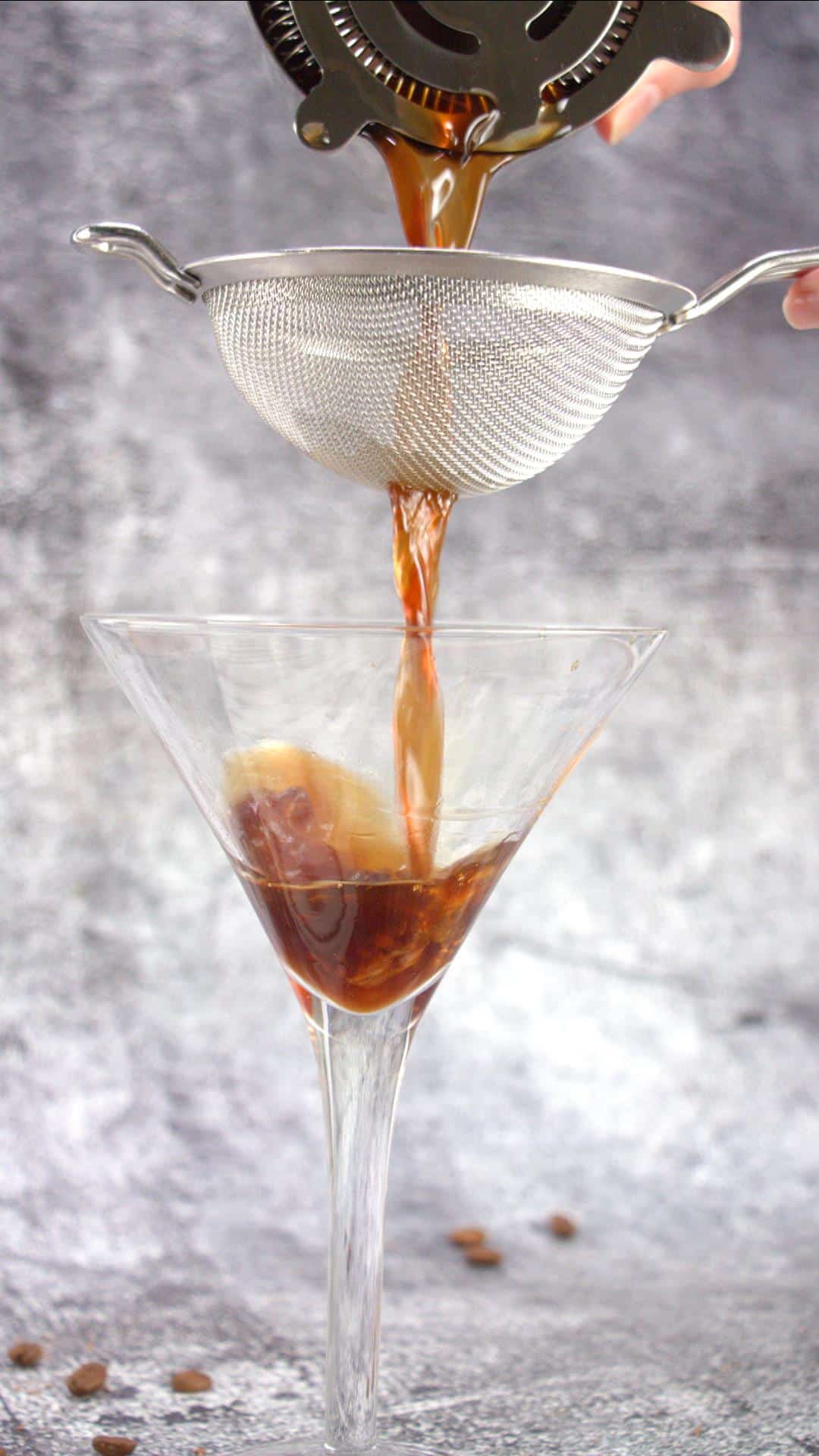 Pouring a homemade chocolate espresso martini into a glass - Hostess At Heart