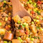 A wooden spoon lifting a serving of Cowboy Stew made of ground beef, sausage, potatoes, corn, peas, and beans in a tomato-based broth, garnished with fresh parsley. Hostess At Heart