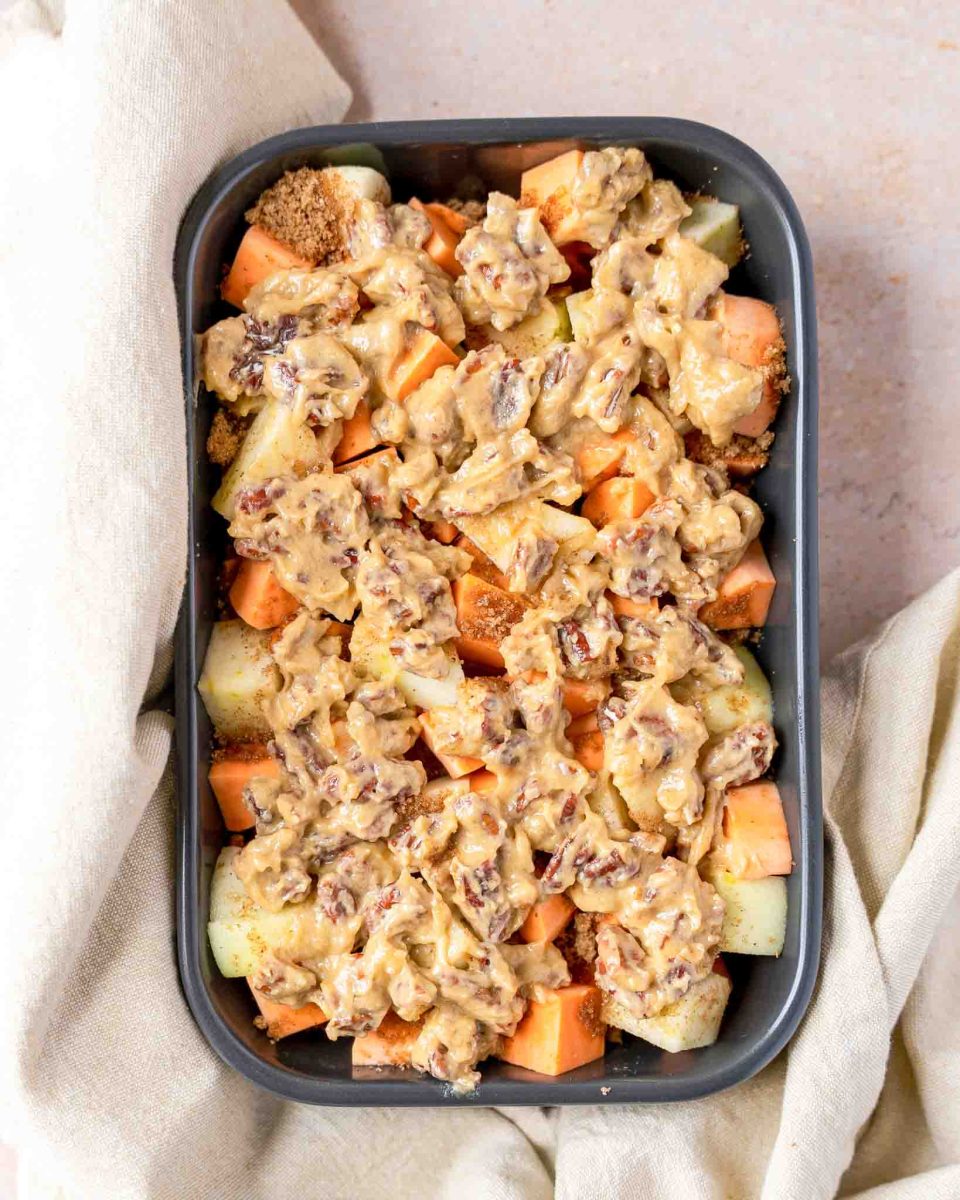 Unbaked sweet potato casserole with pecan topping ready for oven - Hostess At Heart