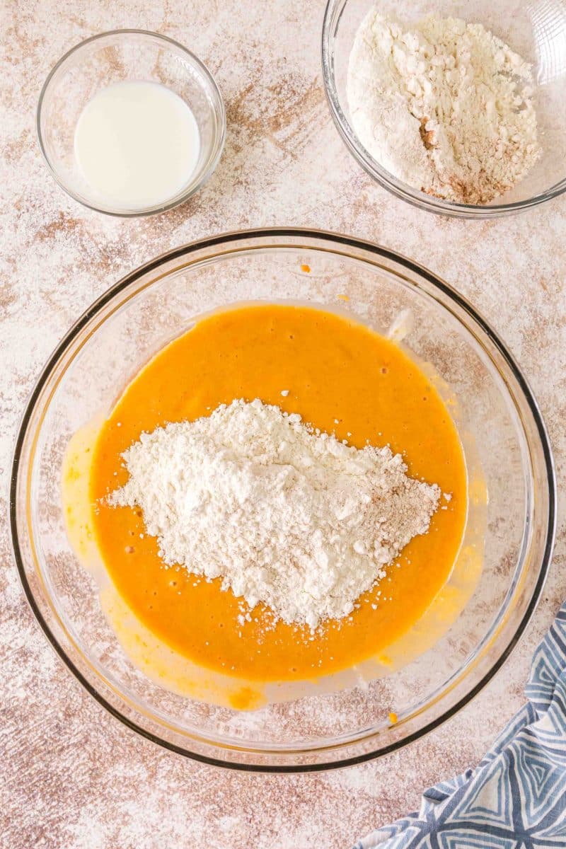 Folding flour mixture into wet pumpkin muffin batter alternating with milk - Hostess At Heart