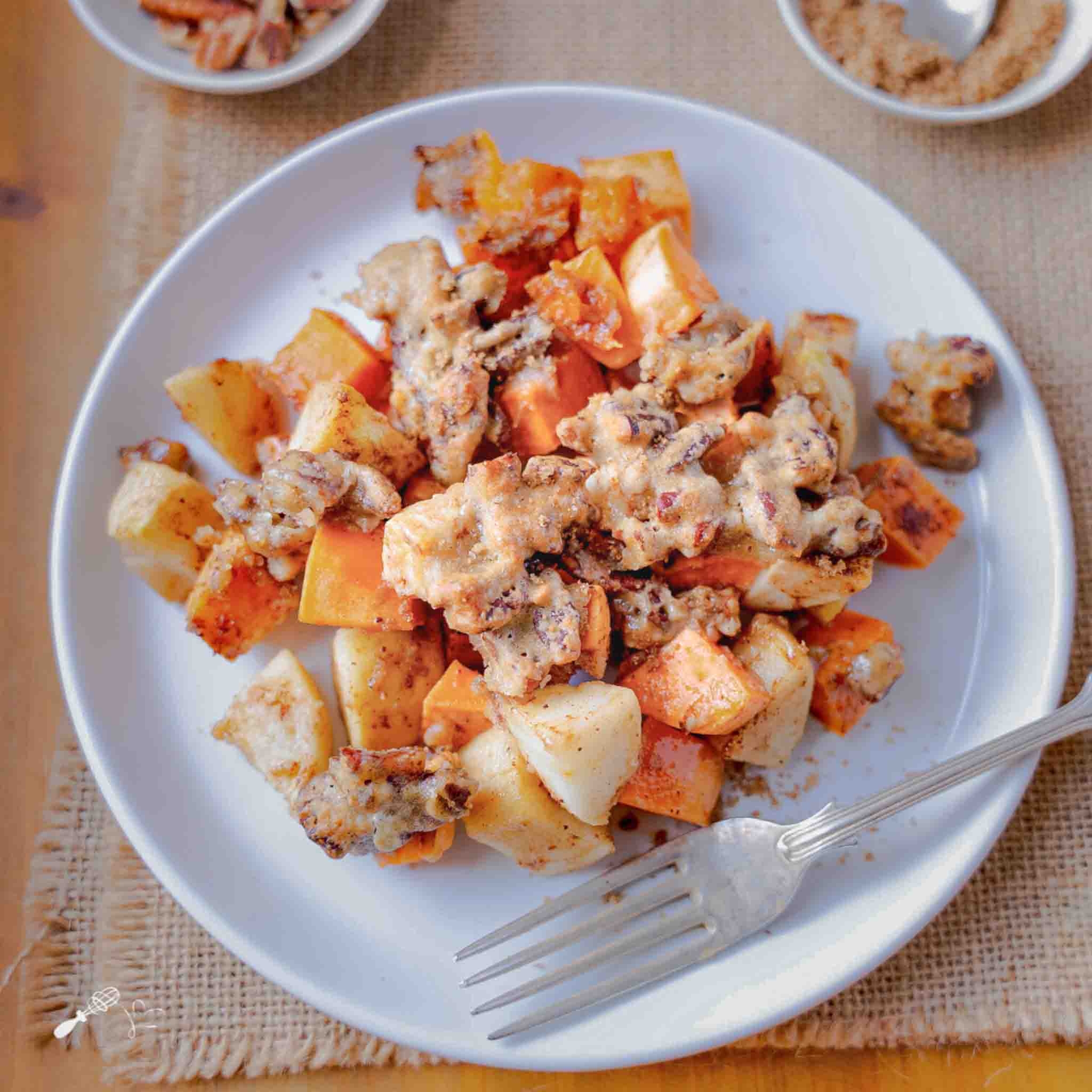Individual serving of sweet potato apple casserole on white plate with a fork - Hostess At Heart