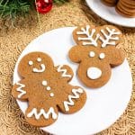 Top down view of decorated gingerbread cut out cookies shaped into a man and a reindeer. Hostess At Heart
