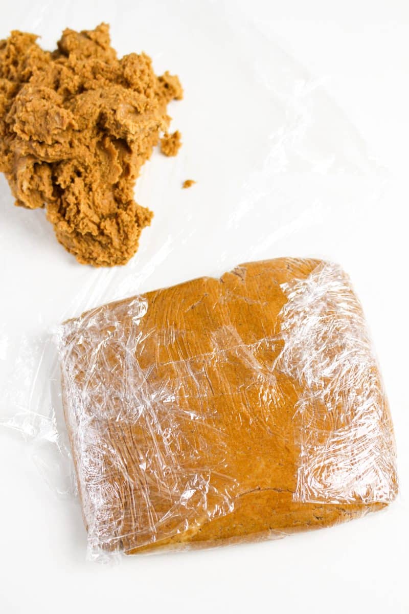 Gingerbread cookie dough wrapped in plastic wrap before placing it in the refrigerator to chill - Hostess At Heart