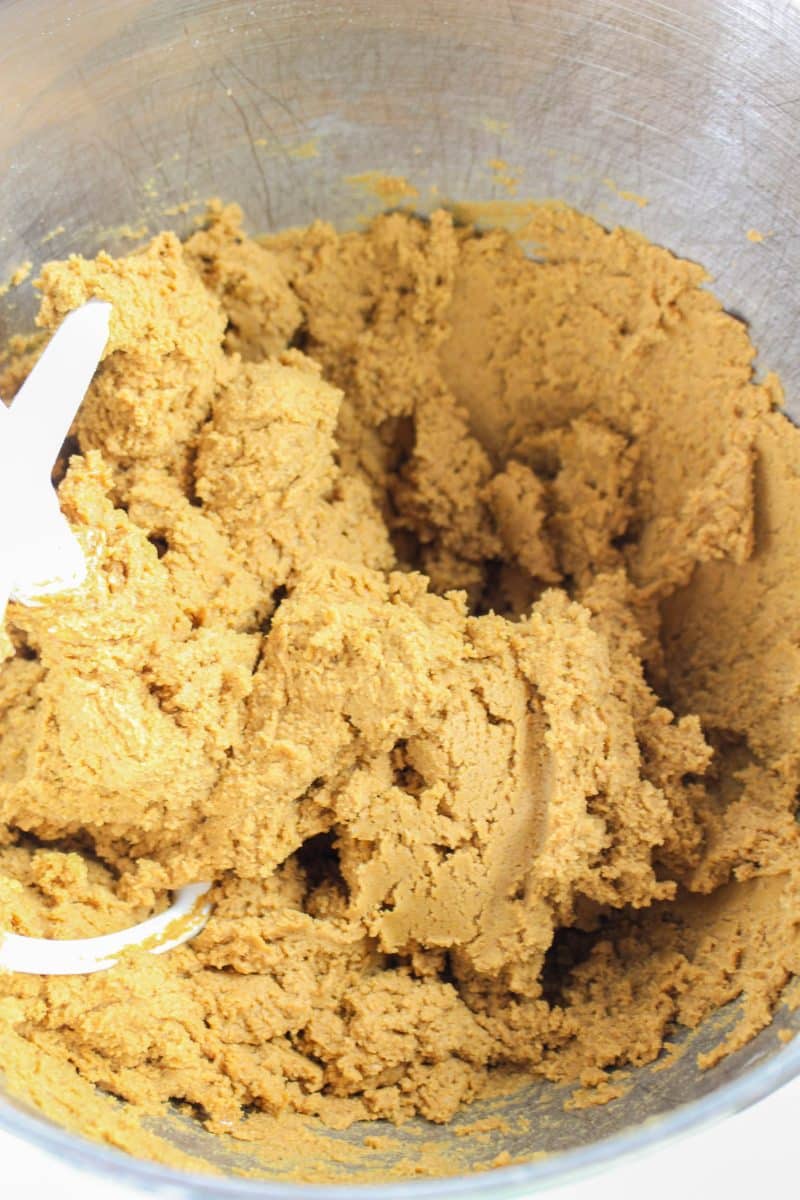 Thick and dense gingerbread cookie dough in the bowl of an electric mixer - Hostess At Heart