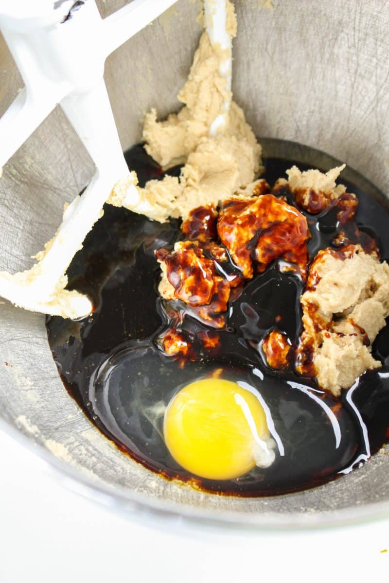 An egg and molasses added to a bowl of whipped brown sugar and butter - Hostess At Heart
