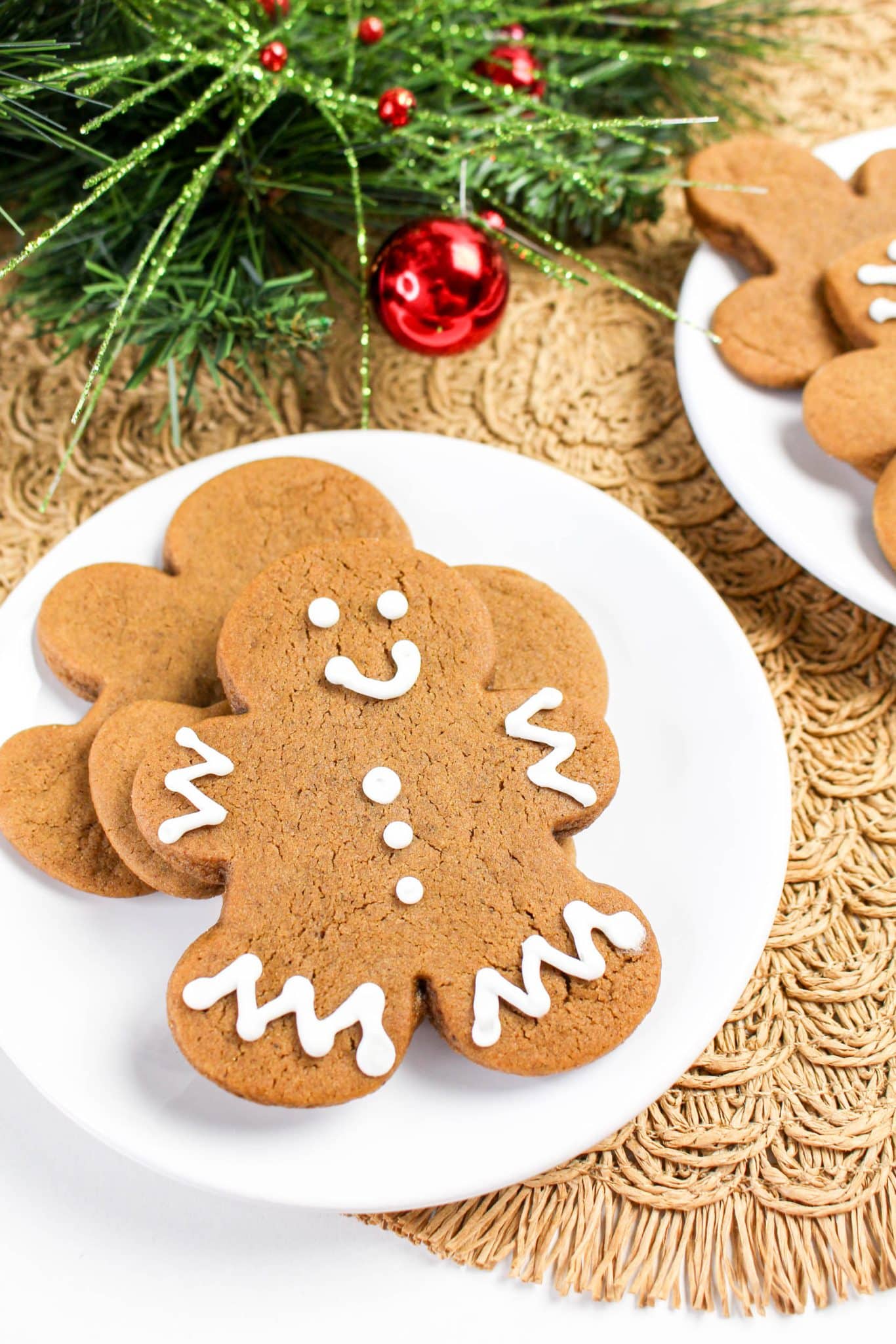 A cut out gingerbread cookie that's been pipped with royal frosting - Hostess At Heart