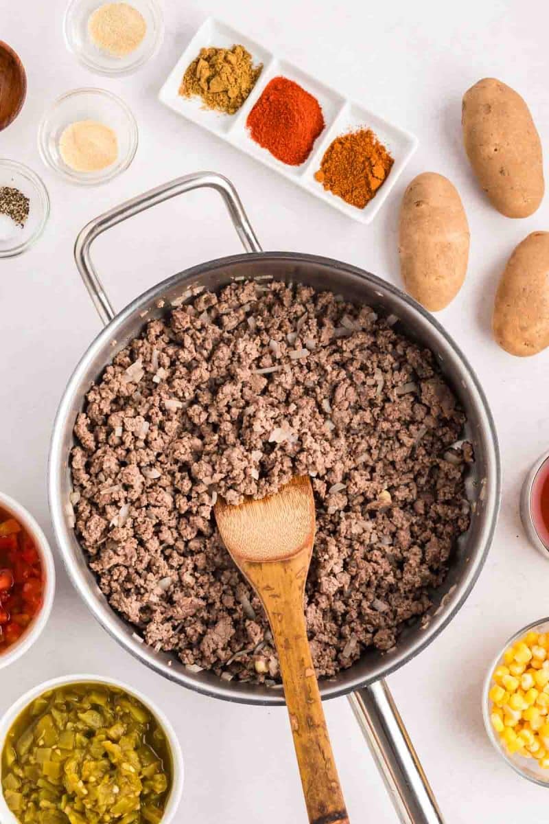 Browned ground beef with diced onions and garlic in a large skillet. Hostess At Heart