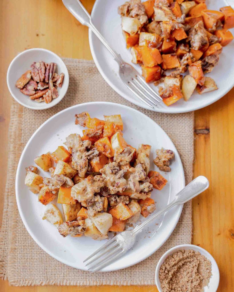 Top down view of individual serving of sweet potato apple casserole on white plates - Hostess At Heart