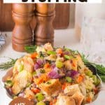 An image for Pinterest of Golden brown sourdough stuffing in a white baking dish with crispy edges and fresh herbs - Hostess At Heart