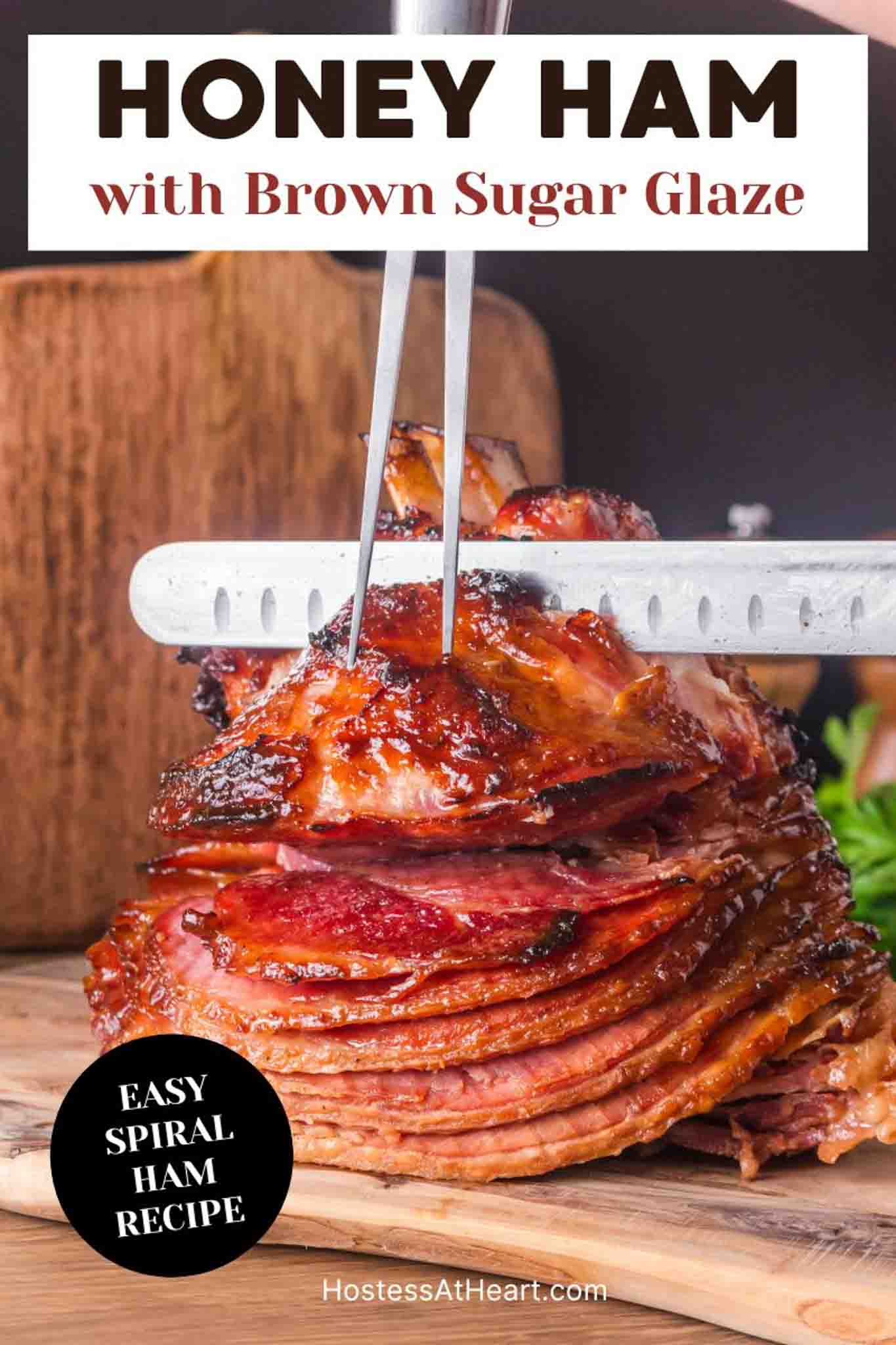 An image for Pinterest of a whole honey baked ham on wooden cutting board ready to slice showing caramelized exterior - Hostess At Heart