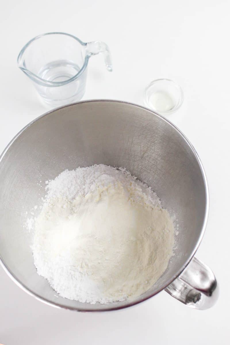 Powdered Sugar and meringue powder in the bowl of an electric mixer - Hostess At Heart