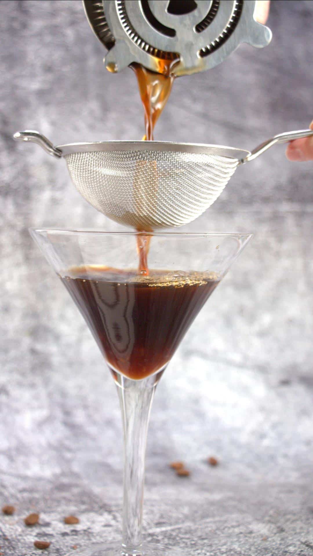 Pouring a chocolate espresso martini into a glass - Hostess At Heart